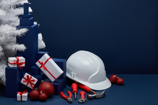 Construction tools, hard hat and Christmas decorations. Christmas and New Year construction
