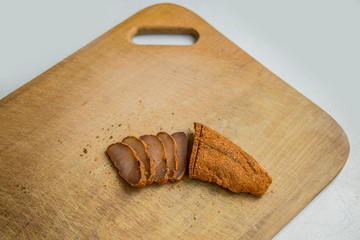 raw smoked horse meat Basturma traditional Armenian cuisine tasty dish wooden cutting board background textured surface concept food photography, copy space