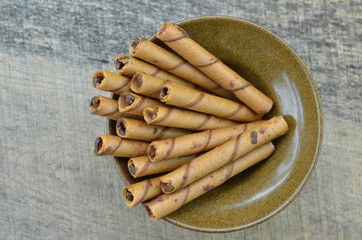 Chocolate waffle roll stick in brown bowl