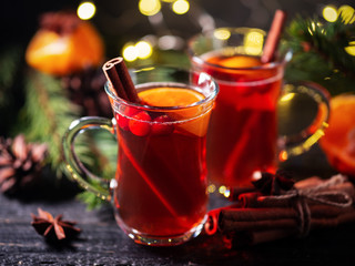 Two glasses of traditional Christmas and winter hot drink mulled wine of red wine with cinnamon, anise, berries and orange