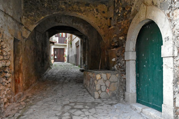 An alley between the old houses of a mountain village in the region Campania, Italy
