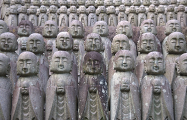 Fototapeta na wymiar standing stone buddhist statues in a temple