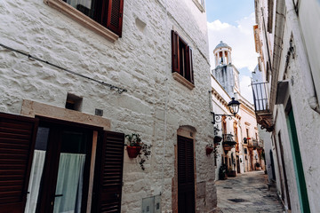 Streets with houses with whitewashed walls of the typical Italian city of Locorotondo.