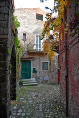 Fototapeta na wymiar An alley between the old houses of a mountain village in the region Campania, Italy