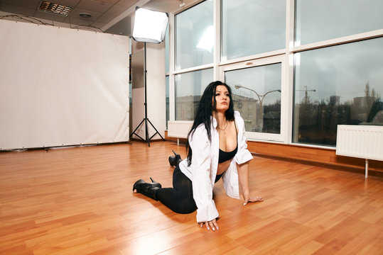 Attractive girl with a good figure dancing strip-plastic in the dance class. Strip-dance. Frame up strip. Sport.