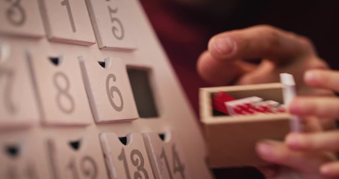 Handheld view of child and advent calendar