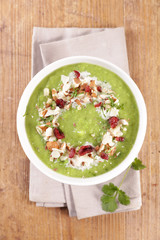 broccoli soup with cream and nuts in bowl