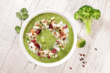broccoli soup with cream and nuts in bowl