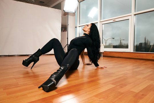 Attractive girl with a good figure dancing strip-plastic in the dance class. Strip-dance. Frame up strip. Sport.