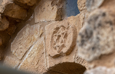 Fototapeta premium Star of David carved from stone over the entrance to the Jewish part of the tomb of the prophet Samuel on Mount Joy near Jerusalem in Israel