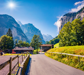 Colorful summer view of Lauterbrunnen village with asphalt road. Bright outdoor scene in Swiss...