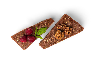 Slice of chocolate cake with raspberry and walnut isolated on white background.