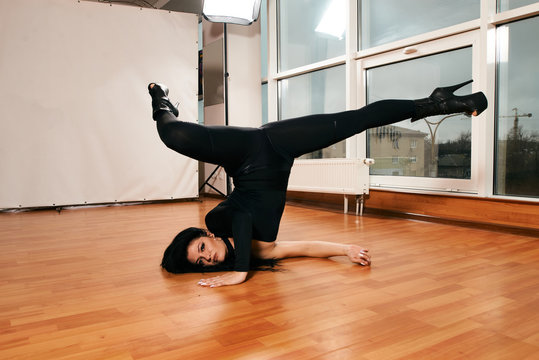 Attractive girl with a good figure dancing strip-plastic in the dance class. Strip-dance. Frame up strip. Sport.