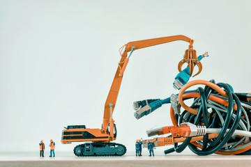 Workers unraveling the tangle of network cables