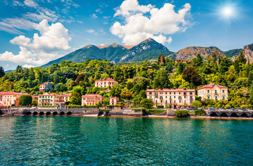 Fototapeta na wymiar Picturesque summer view from ferry boat of Cadenabbia town. Bright morning scene of Como lake, Italy, Europe. Traveling concept background.