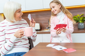 Female hiding her cards from a girl
