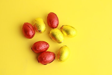 chocolate easter eggs, wrapped in yellow and red paper