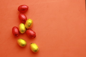 chocolate easter eggs, wrapped in yellow and red paper