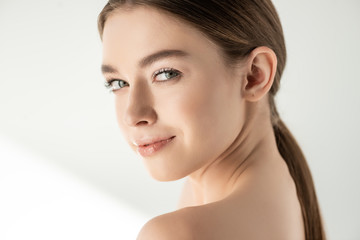 Fototapeta premium Beautiful naked smiling woman posing on white