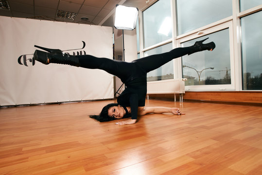 Attractive girl with a good figure dancing strip-plastic in the dance class. Strip-dance. Frame up strip. Sport.