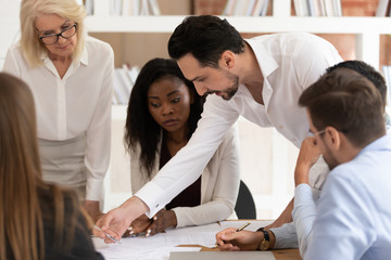 Middle east boss explaining contract clause to multiracial employees