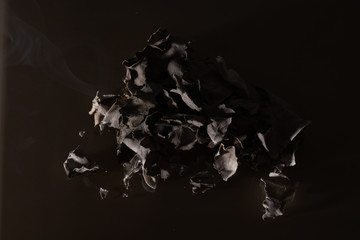 Burning bill of 200 Ukrainian hryvnia. On a dark background.