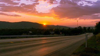Picture of the main road and grass flowers at sunset.