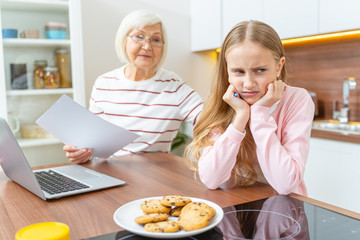 Senior Caucasian lady comforting her depressed granddaughter