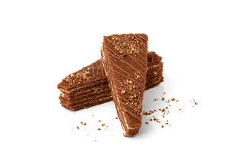 Slice of chocolate cake with milk filling and chocolate isolated on white background.