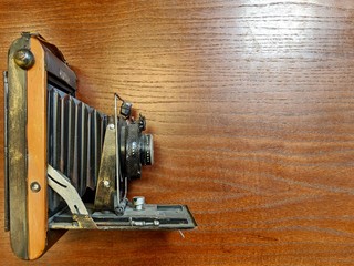 Vintage and old clock on wooden table. Space for inserting text, advertising, design, business.
