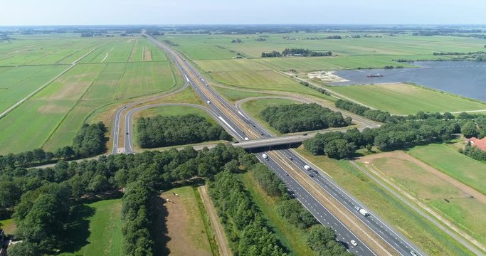 Stationary Shot of the A7 Highway on a Sunny Day, Exit 28, Near Drachten and Beetsterzwaag, Traffic consists of Cars, Trucks and Caravans, Friesland, Netherlands / Holland &ndash; 4K Drone Footage