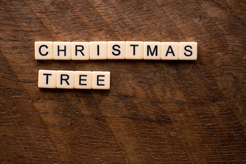the words Christmas tree on wood