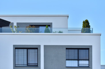 Balcony and observation deck with garden in a modern apartment building against a blue sky