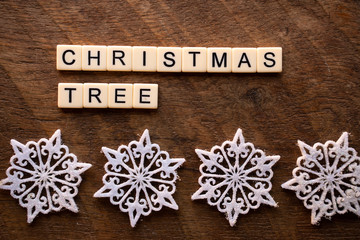 the words Christmas tree on wood