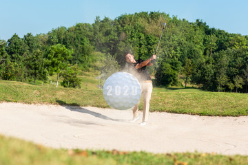 Profession asian Golfer hitting golf ball out of a sand trap to New year 2020 for new healthy and...