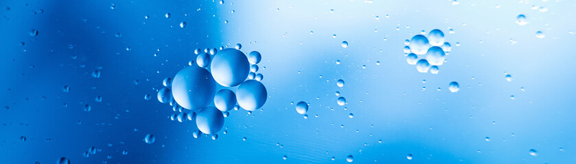 oil with bubbles on on dark blue background. Abstract background.