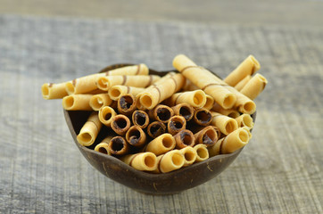 Chocolate waffle roll and vanilia waffle in bowl wooden