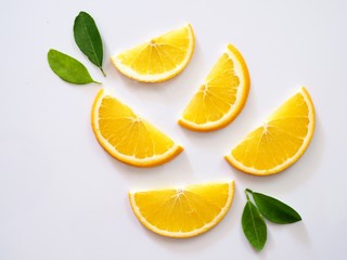 above of bright citrus orange piece sliced fruit with green leaf isolated on white background.