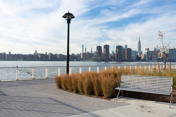 Empty Bench with Plants at a Park in Greenpoint Brooklyn New York looking out towards the East River and the Manhattan Skyline