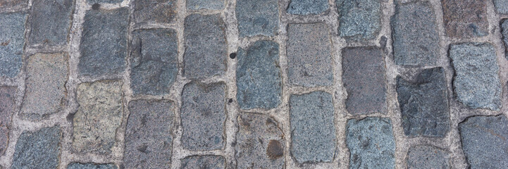 Panoramic background of old cobblestone pavement. Close Up