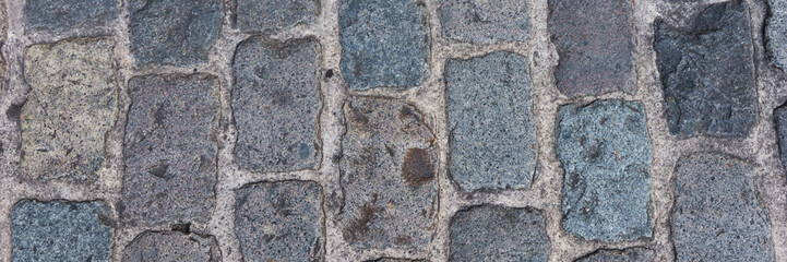 Panoramic background of old cobblestone pavement. Close Up
