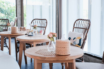 Tables and booths in empty, sunny cafe