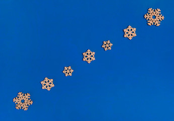 Christmas composition. Snowflakes on a blue background. Flat lay, copy space, top view, minimalism, new year.