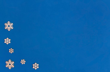 Christmas composition. Snowflakes on a blue background. Flat lay, copy space, top view, minimalism, new year.