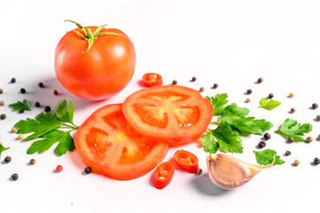 Pattern of vegetables. Food background. Composition of tomatoes, chili peppers, parsley, garlic and spices on white background.