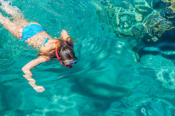 teenage girl enjoy by swimming and snorkeling in Red sea clean water in summer vacation time summer...