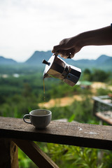pouring coffee from mokapot into a cup in mountain view