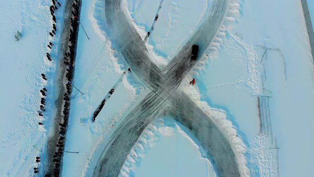 Aerial shot of winter drift competition on Russian Classics Lada VAZ-2107. Taken by drone