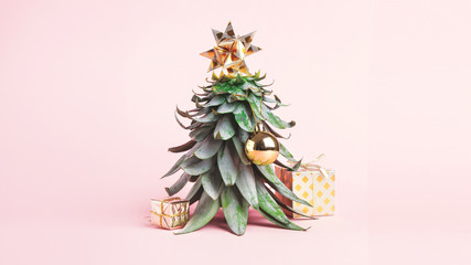 Pineapple leaves in the form of a Christmas tree with decorations. Creative christmas concept. 2020 year