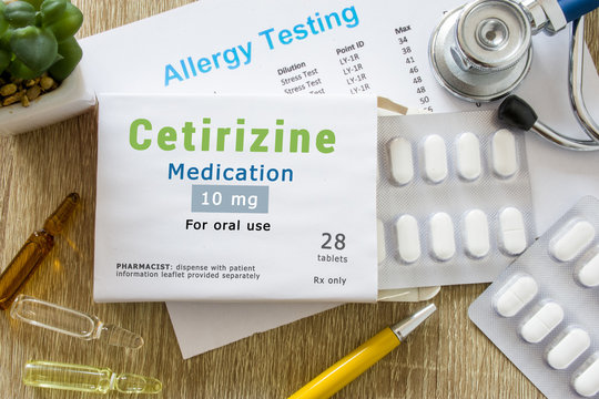Cetirizine medication or allergy drug concept photo. On  doctor table is pack with words "Cetirizine medication" and pills for treatment of allergy and hypersensitivity